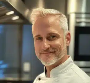 Chef Rayan smiling in the kitchen, sharing his passion for healthy low-carb, high-protein recipes